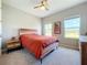 Bedroom with wood-toned bed frame, carpet, and ceiling fan at 15305 Isla Palma Ln, Nokomis, FL 34275