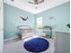 Charming Bedroom with a crib, changing table, and whimsical whale wall decals at 15305 Isla Palma Ln, Nokomis, FL 34275