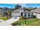 Single-story house with white exterior and gray roof at 15305 Isla Palma Ln, Nokomis, FL 34275