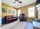 Bright home office features a leather sofa, desk, and ample natural light at 15305 Isla Palma Ln, Nokomis, FL 34275