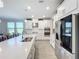 Modern kitchen with white cabinetry, quartz countertops, and stainless steel appliances at 15305 Isla Palma Ln, Nokomis, FL 34275