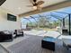 Relaxing outdoor patio with seating area and screened enclosure at 15305 Isla Palma Ln, Nokomis, FL 34275