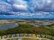 Aerial view of a large community, showcasing various homes, streets, and a lake at 16219 Tradewind Ter, Bradenton, FL 34211