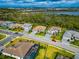 Aerial perspective of a residential street with houses and a red car parked at 16219 Tradewind Ter, Bradenton, FL 34211