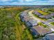 Aerial view of houses along a tree-lined street in a new residential development at 16219 Tradewind Ter, Bradenton, FL 34211