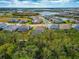 Aerial view of a single Gathering home with a backyard surrounded by trees at 16219 Tradewind Ter, Bradenton, FL 34211