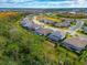 An aerial view showcasing a community of luxury homes with lush green surroundings at 16219 Tradewind Ter, Bradenton, FL 34211