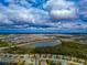 Aerial view of a house in a residential neighborhood with a lake nearby at 16219 Tradewind Ter, Bradenton, FL 34211