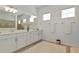 Bright bathroom featuring double vanity and a frameless shower at 16219 Tradewind Ter, Bradenton, FL 34211