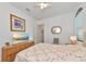 Bright bedroom with a queen bed, ceiling fan, and wood furniture at 16219 Tradewind Ter, Bradenton, FL 34211