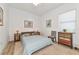 Bright bedroom featuring a queen bed, wood accents, and a window with blinds at 16219 Tradewind Ter, Bradenton, FL 34211