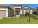 Front view of a house with a double door entry and mature landscaping at 16219 Tradewind Ter, Bradenton, FL 34211