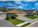 A house exterior with a tile roof, three-car garage, and well-manicured lawn at 16219 Tradewind Ter, Bradenton, FL 34211