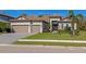 House exterior showcasing a tile roof, two-car garage, and lush landscaping at 16219 Tradewind Ter, Bradenton, FL 34211