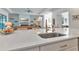 Kitchen island with sink, looking toward living room with fireplace at 16219 Tradewind Ter, Bradenton, FL 34211