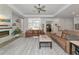 Living room with two sofas, coffee table, and views of the entry and kitchen at 16219 Tradewind Ter, Bradenton, FL 34211