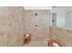 Large walk-in shower with beige tiles and a rainfall shower head at 16219 Tradewind Ter, Bradenton, FL 34211