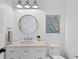 Charming bathroom with a round mirror and pedestal sink at 1686 North Dr, Sarasota, FL 34239