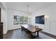 Bright dining room with wooden table, chandelier and white walls at 1686 North Dr, Sarasota, FL 34239