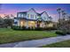 Two-story home with a metal roof and landscaped lawn at 1686 North Dr, Sarasota, FL 34239