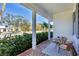 Relaxing front porch with brick flooring and wicker chairs at 1686 North Dr, Sarasota, FL 34239