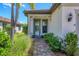 Attractive front entry with gray door and brick walkway at 17649 Northwood Pl, Bradenton, FL 34202