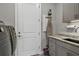 Laundry room with washer, dryer, and ironing board at 17649 Northwood Pl, Bradenton, FL 34202