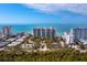 Aerial view of beachfront condo building with pool and ocean views at 1800 Benjamin Franklin Dr # B408, Sarasota, FL 34236