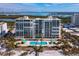 Aerial view of beachfront condo building and pool at 1800 Benjamin Franklin Dr # B408, Sarasota, FL 34236