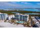 Aerial view of beachfront condo building and pool at 1800 Benjamin Franklin Dr # B408, Sarasota, FL 34236