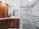 Modern bathroom with marble shower and vanity at 1800 Benjamin Franklin Dr # B408, Sarasota, FL 34236