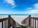 Wooden staircase leads to the beach at 1800 Benjamin Franklin Dr # B408, Sarasota, FL 34236