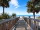 Wooden boardwalk leads to the beach at 1800 Benjamin Franklin Dr # B408, Sarasota, FL 34236