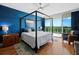 Main bedroom with a canopy bed, ocean view and hardwood floors at 1800 Benjamin Franklin Dr # B408, Sarasota, FL 34236