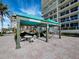 Two shaded cabanas with tables and chairs at 1800 Benjamin Franklin Dr # B408, Sarasota, FL 34236