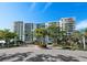 Exterior view of the building, highlighting its architectural design and landscaping at 1800 Benjamin Franklin Dr # B408, Sarasota, FL 34236