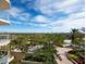 Stunning panoramic view from the balcony, showcasing lush landscaping and a partial ocean view at 1800 Benjamin Franklin Dr # B408, Sarasota, FL 34236