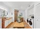 Bright bathroom featuring double sink, decorative tile, a shower and convenient washer and dryer at 1864 Clematis St, Sarasota, FL 34239