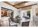 Bright dining room with statement lighting fixture, round table and chairs, and view of the yard at 1864 Clematis St, Sarasota, FL 34239