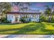 Charming home exterior with red tile roof, lush landscaping, and a green lawn at 1864 Clematis St, Sarasota, FL 34239