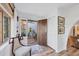 Bright foyer with hardwood floors, a decorative chair, and a glimpse into an outdoor courtyard at 1864 Clematis St, Sarasota, FL 34239