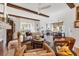 Spacious living room with wood beams, open layout, leading to a dining area and decorative elements at 1864 Clematis St, Sarasota, FL 34239