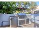 Outdoor kitchen featuring a stainless steel grill, refrigerator, and storage at 1864 Clematis St, Sarasota, FL 34239