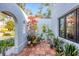 Inviting outdoor tiled patio with plants creating a peaceful retreat, perfect for relaxation and entertaining at 1864 Clematis St, Sarasota, FL 34239