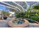 Enclosed pool and patio featuring a unique pool and spa combination surrounded by mature landscaping at 1864 Clematis St, Sarasota, FL 34239