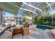 Outdoor living with covered, screened pool and plenty of lush tropical landscaping at 1864 Clematis St, Sarasota, FL 34239