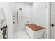 Spa-like bathroom with walk-in shower, soaking tub, and marble tile at 1990 Main St # 6, Sarasota, FL 34236