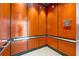 Modern elevator with wood paneling at 1990 Main St # 6, Sarasota, FL 34236