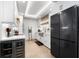 Modern white kitchen with black appliances at 1990 Main St # 6, Sarasota, FL 34236