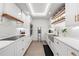 Modern kitchen with white cabinets, quartz countertops, and a concrete farmhouse sink at 1990 Main St # 6, Sarasota, FL 34236